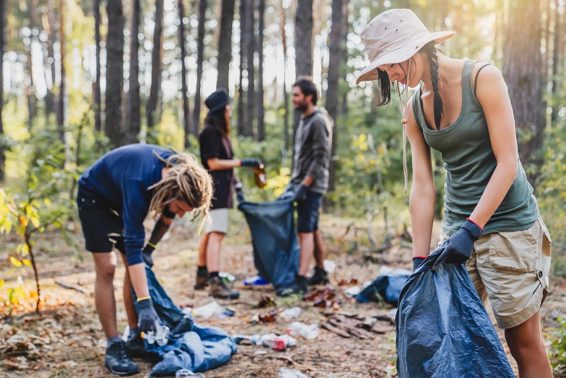 People collecting litter in forest