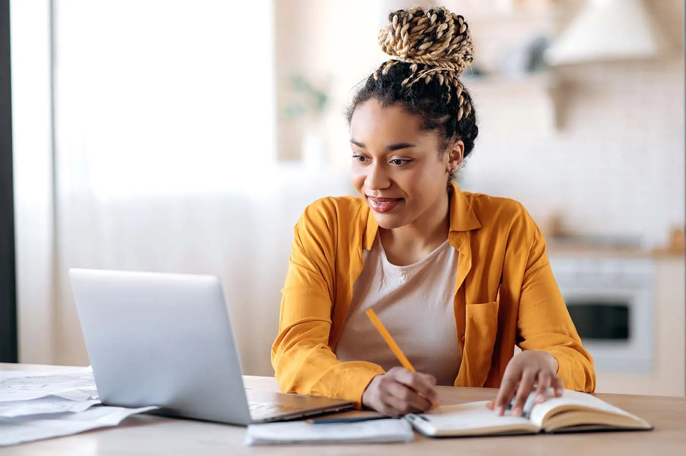 One student studying with book and laptop